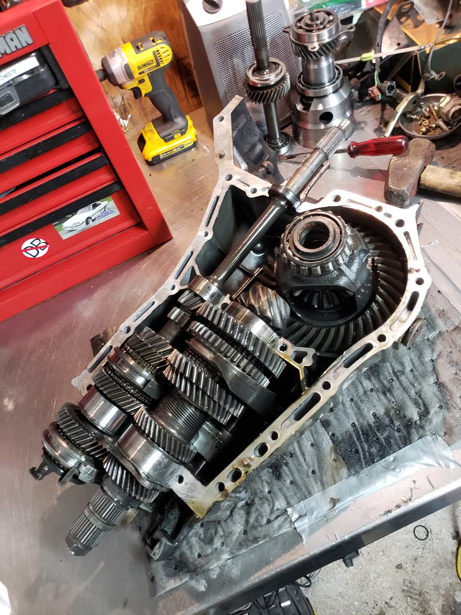 Opened manual transmission showing gear sets during a rebuild