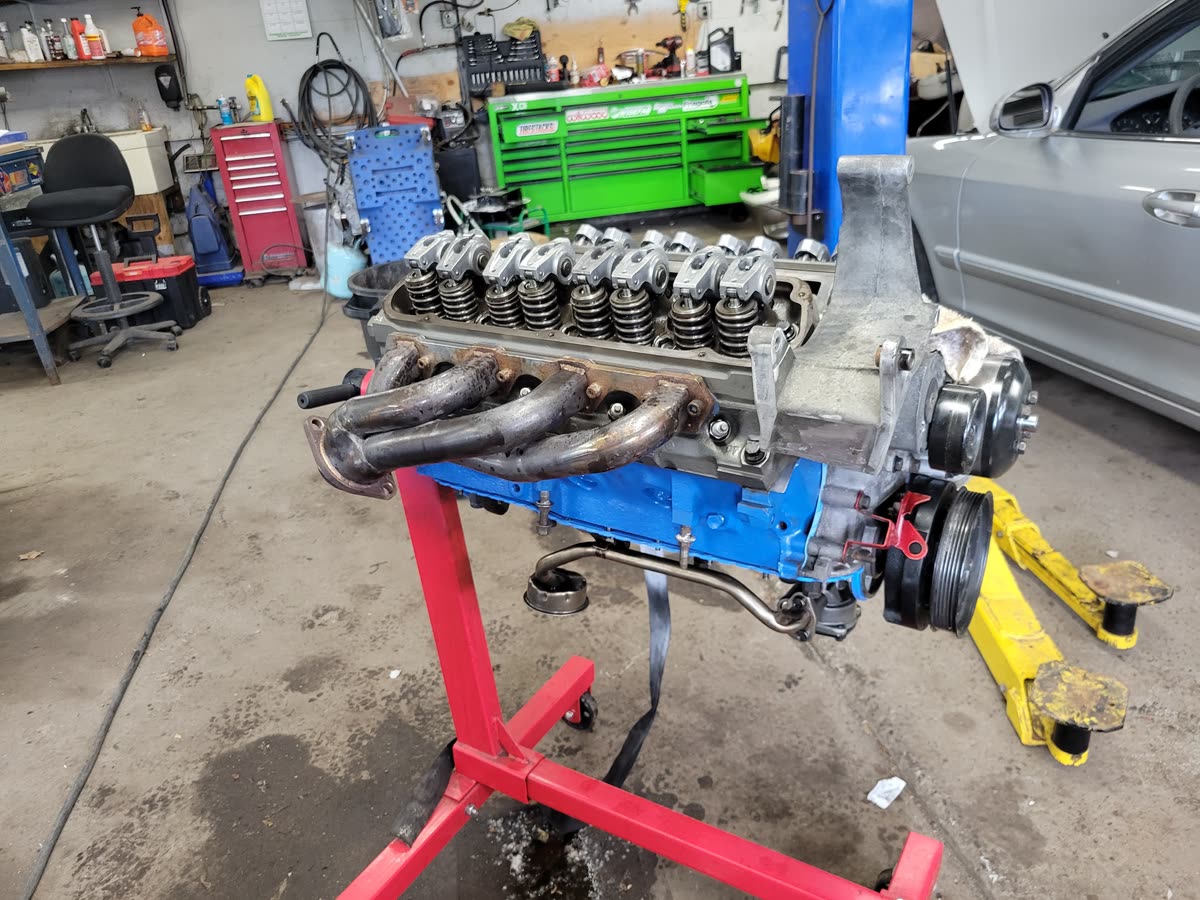 Freshly built performance engine with headers mounted on an engine stand