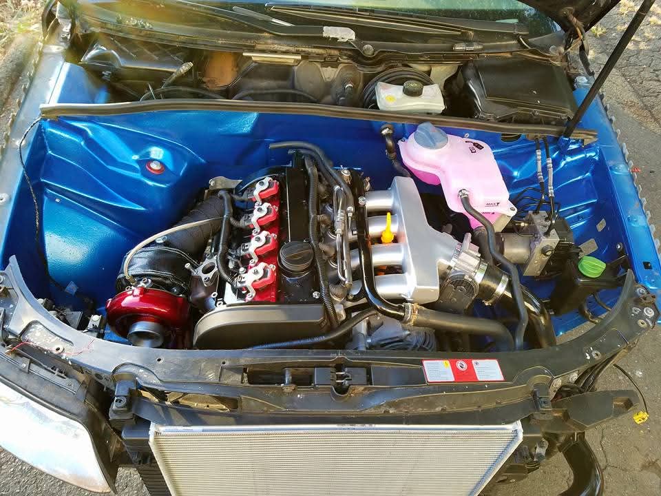 Clean custom engine bay painted blue with a turbocharged engine